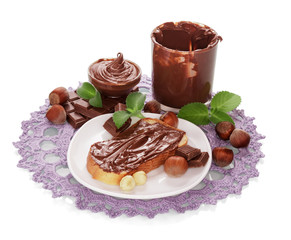 Bowls with chocolate cream, slice bread, hazelnuts, mint leaves isolated..