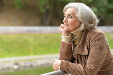 Beautiful middle-aged woman in autumn park