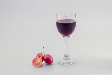 glass of wine and grapes, isolated on white