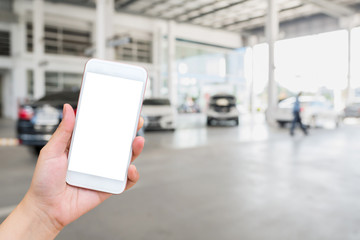 Woman using mobile smartphone with blur cars parking