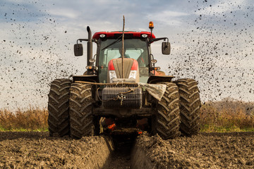 Tractor with double wheeled ditcher digging drainage canal © oticki