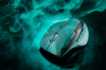 High technology computer gaming mouse in dark green tone with smoke