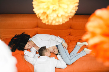 beautiful and gentle pregnant woman with her husband lying on th