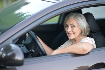 Obraz na płótnie Canvas Senior Woman Driving Car