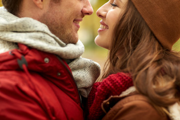 close up of happy young couple kissing outdoors