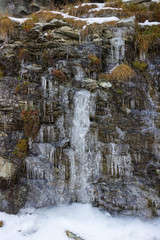 Autumn in the mountains. Icicles on the rocks. Aosta valley, Italy