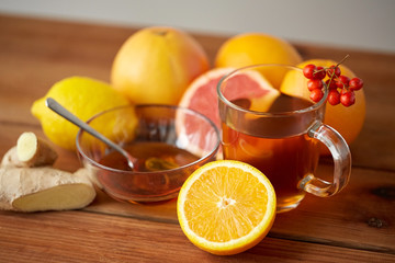 tea with honey, lemon and ginger on wood