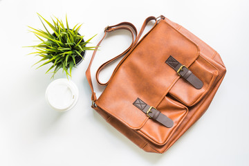 Men's fashion leather bag with tree decoration and coffee cup, flat lay, top view background