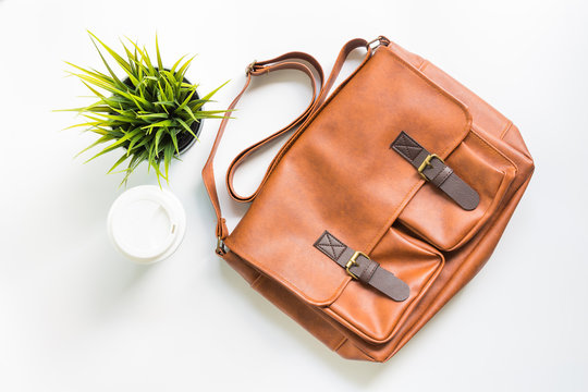 Men's Fashion Leather Bag With Tree Decoration And Coffee Cup, Flat Lay, Top View Background