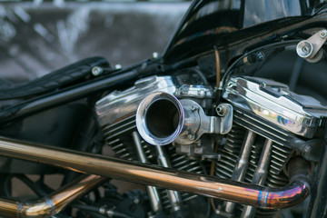 Motorcycle engine close-up. Chrome, shiny parts, wheels, exhaust.