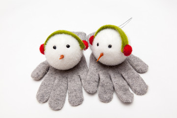 snowman toy for christmas tree decoration on woolen gloves, on white backgrounds