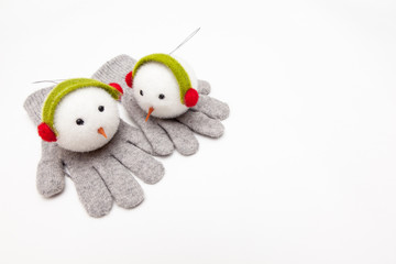 snowman toy for christmas tree decoration on woolen gloves, on white backgrounds