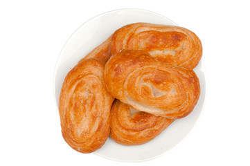 Sweet buns on plate isolated on white. Home made bakery.