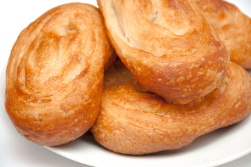 Sweet buns on plate isolated on white. Home made bakery.