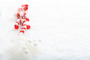 Candy canes and christmas decoration on snow