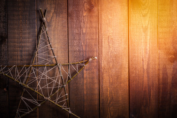 wooden star on a brown wooden background