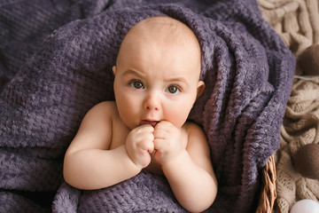 Incredible and charming newborn baby lying in a basket