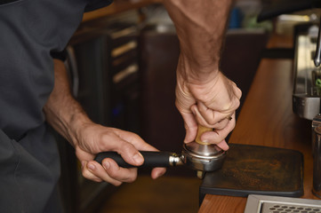 barista close up hands preparing delicious coffee cream operating machine at coffee shop