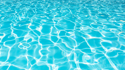 Water Surface in swimming pool with sun reflection