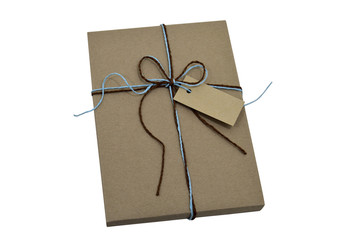 Gift wrap brown paper tie knot with natural string and note,isolated on white with clipping path.