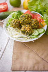 Vertical shot of falafel salad. Nice vegetarian falafel over the vegetable salad