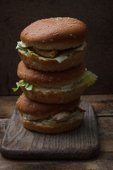 Delicious hamburgers served on wooden planks Tasty hamburger with chicken.