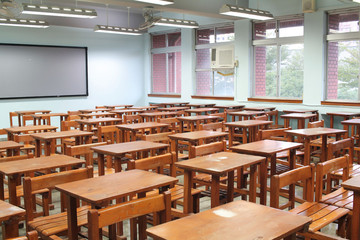 Empty classroom with desks and chairs