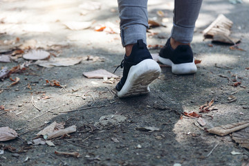 Foot Woman with shoe walking at the park.