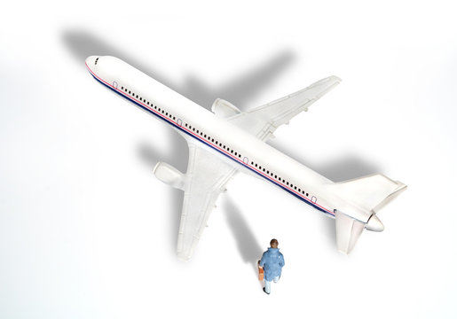 Toy businessman / View of miniature toy, businessman walking and airplane on white background. Top view.