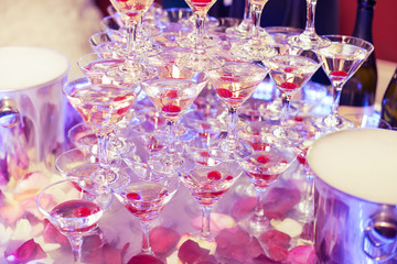 Champagne in glasses with fresh cherry on table - party background