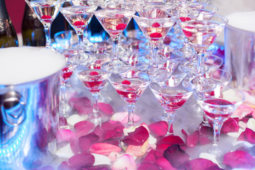 Champagne in glasses with fresh cherry on table - party background