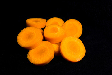 carrot and slices of carrot isolated on black background, food, vegetables, fruits, health