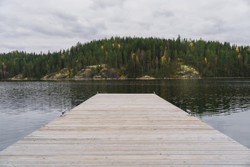 autumn forest and lake landscape from the wooden berth