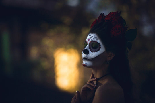 Portrait of a girl with scary artistic Halloween make-up outside