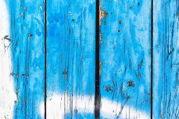 Fototapeta na wymiar Blue painted wooden planks peeling off
