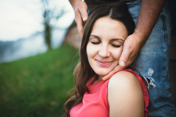 Beautiful pregnant woman with her husband posing outside