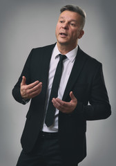 Senior Businessman Speaking and Gesturing