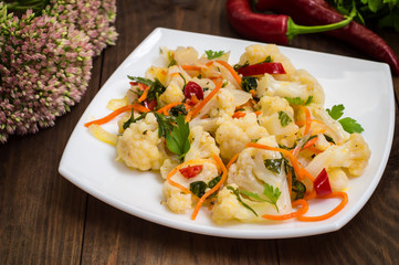 Korean salad of cabbage, carrots, sweet peppers - kimchi. Top view, copy space.