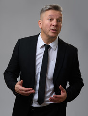 Senior Businessman Speaking and Gesturing