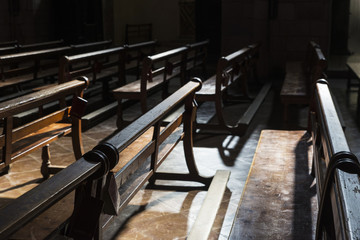 Fototapeta na wymiar Row of wooden benches inside a church