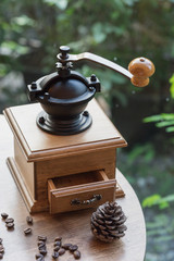 wooden traditional coffee maker with coffee seed on wooden table in coffee shop on natural view at relax coffee time / coffee maker and coffee seed
