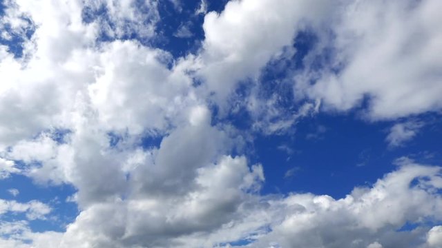 Flow of Clouds in the Blue Sky. Majestic clouds illuminated by the sun. Timelipse