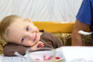 Smiling blond child when feeding