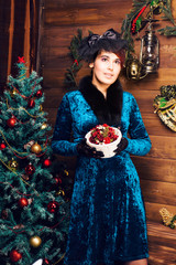 Portrait of the Beautiful woman near Christmas tree.