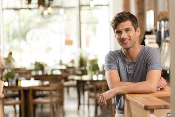 Smiling waiter working in a restaurant