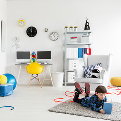 Boy reading a book in his bedroom © Photographee.eu