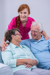 Positive senior couple and carer