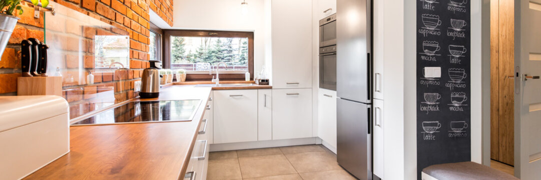 Minimalist kitchen with white cabinets