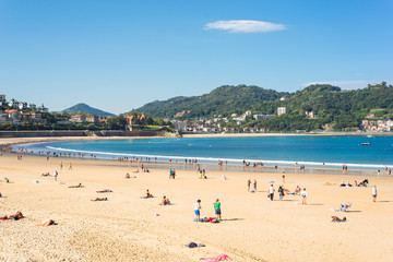 Fototapeta na wymiar Donostia San Sebastian. The Beach of La Concha, a sand beach with shallow waters and tide. It is one of the most famous urban beaches in Europe