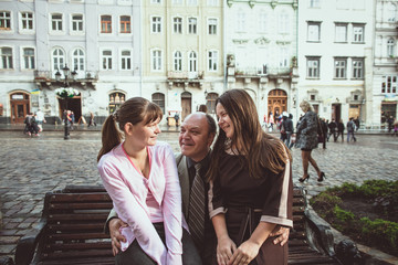 Father and his daughters walking in the old town